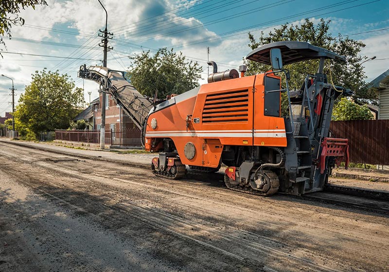 Team finishing the edges of a new asphalt path