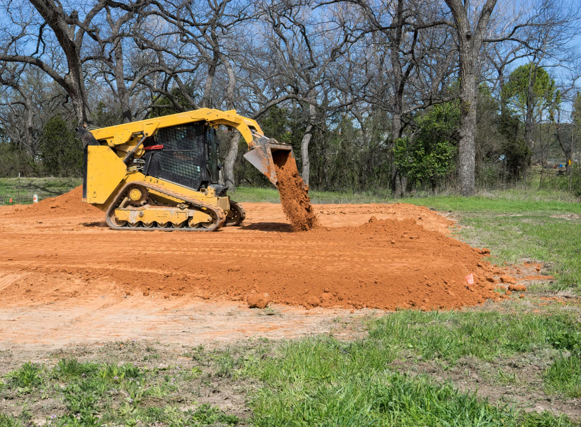 Contractor filling cracks in asphalt pavement